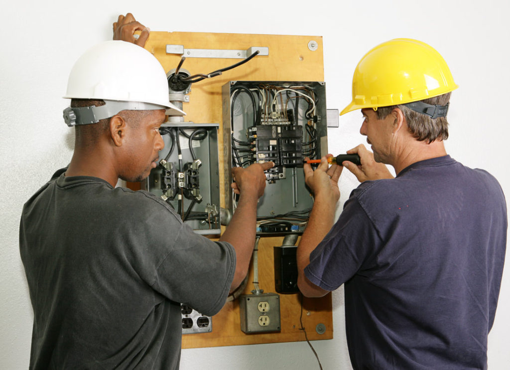 This Is A Picture Of Two Men Working On An Older Electrical Panel For Training Purpose For Delaware County Handyman